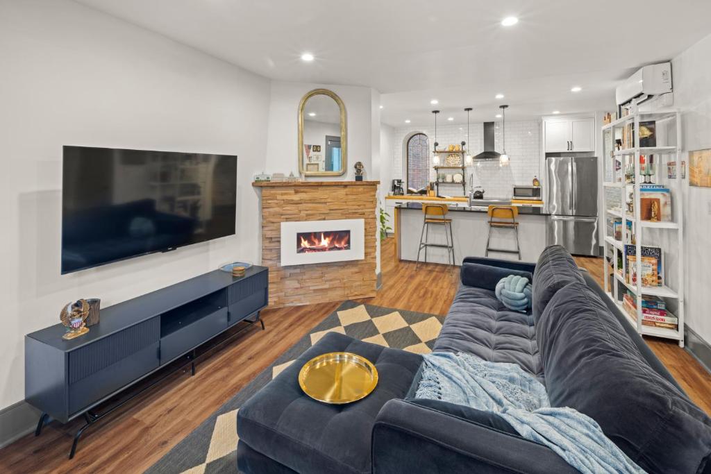a living room with a couch and a fireplace at 2BR Capitol hill delight, with private parking in Washington, D.C.