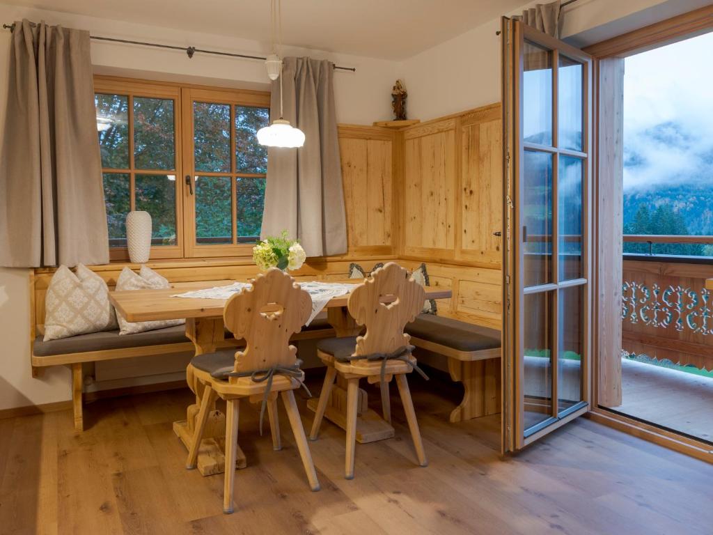a dining room with a table and chairs and a window at Bauernhof Glanzern in Westendorf