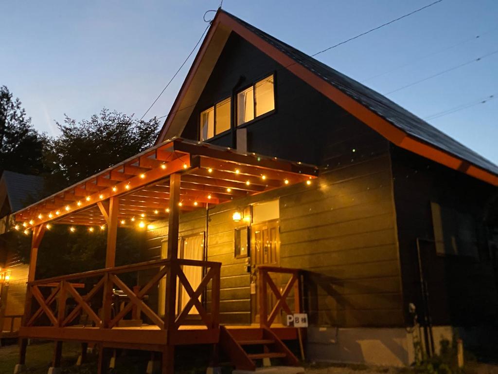 a house with lights on the front of it at 絶景cottage 1棟貸切り 星空B棟 in Anazawa