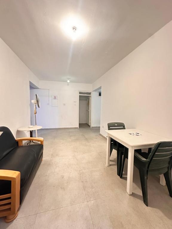 a living room with a couch and a table at RetroChic Apartments in Ayia Napa