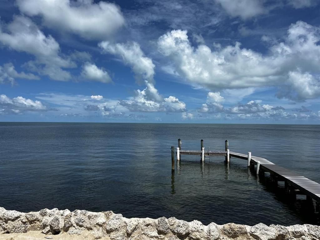 a dock in the middle of a body of water at Caribbean Sunsets in Marathon