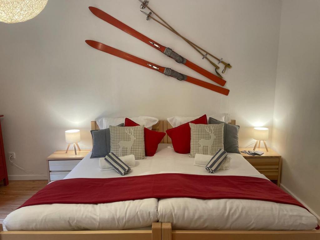a bedroom with a large bed with red and blue pillows at Springhouse in Bad Gastein
