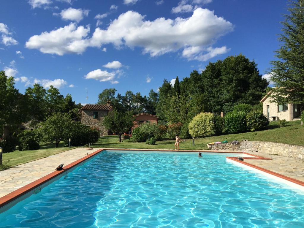 a swimming pool with blue water in a yard at Agricola Caicucci in Montone