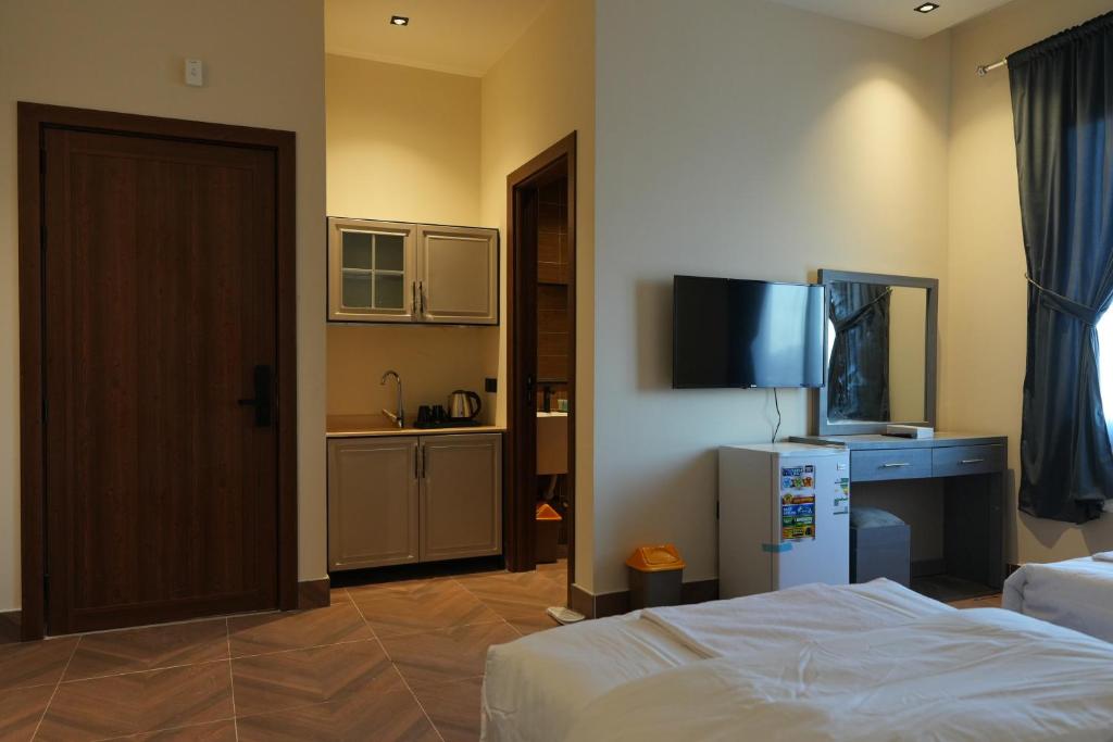 En eller flere senge i et værelse på رايز العارض للشقق المخدومة