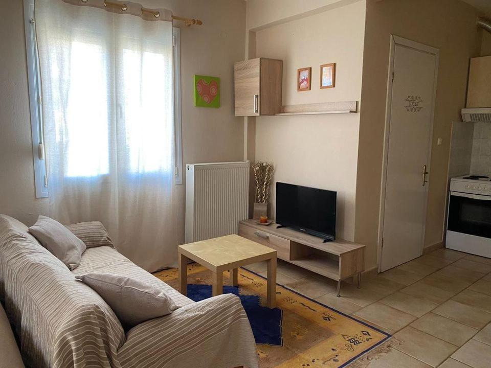 a living room with a couch and a table at Feels like home in Maniákoi