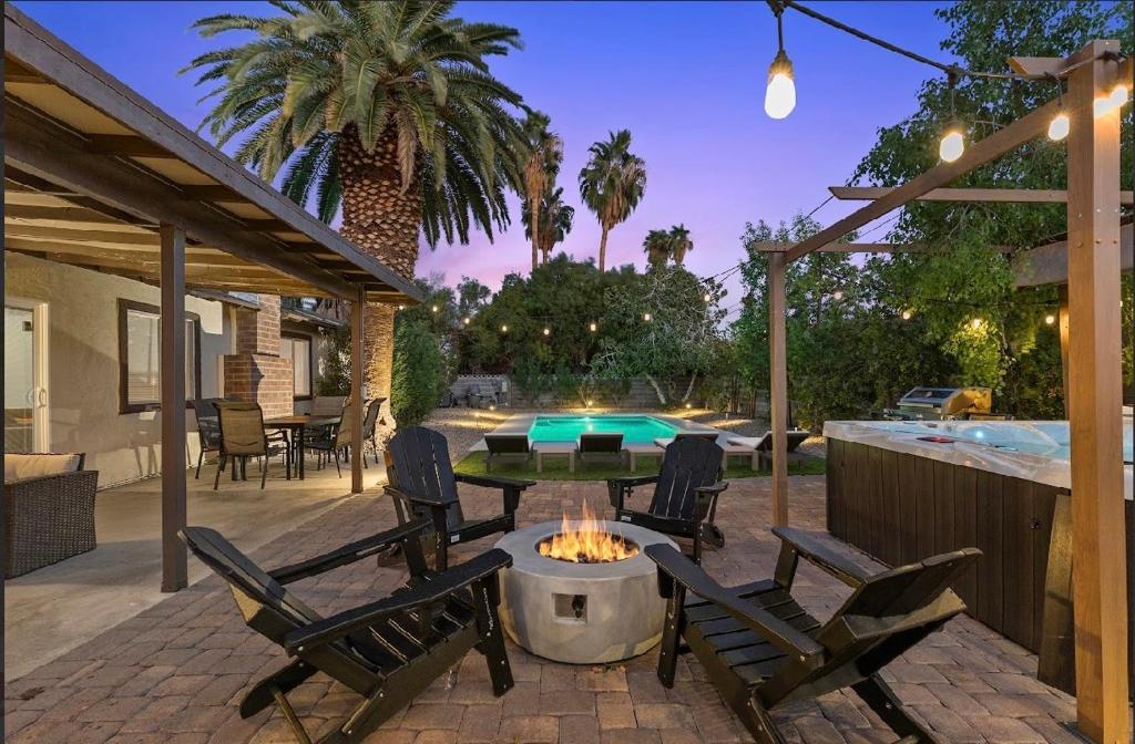 a patio with a table and chairs and a pool at Stylish home with pool and spa in Las Vegas