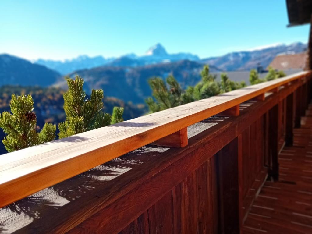 a wooden fence with mountains in the background at Lü de Terza in San Vigilio Di Marebbe