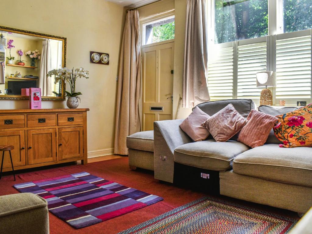 a living room with a couch and a window at Church View in Skipton