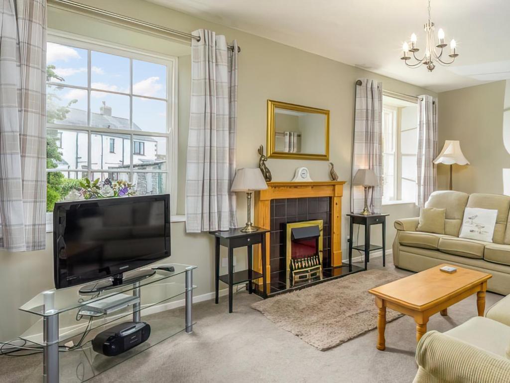 a living room with a television and a fireplace at Six The Square - Uk48869 in Belford