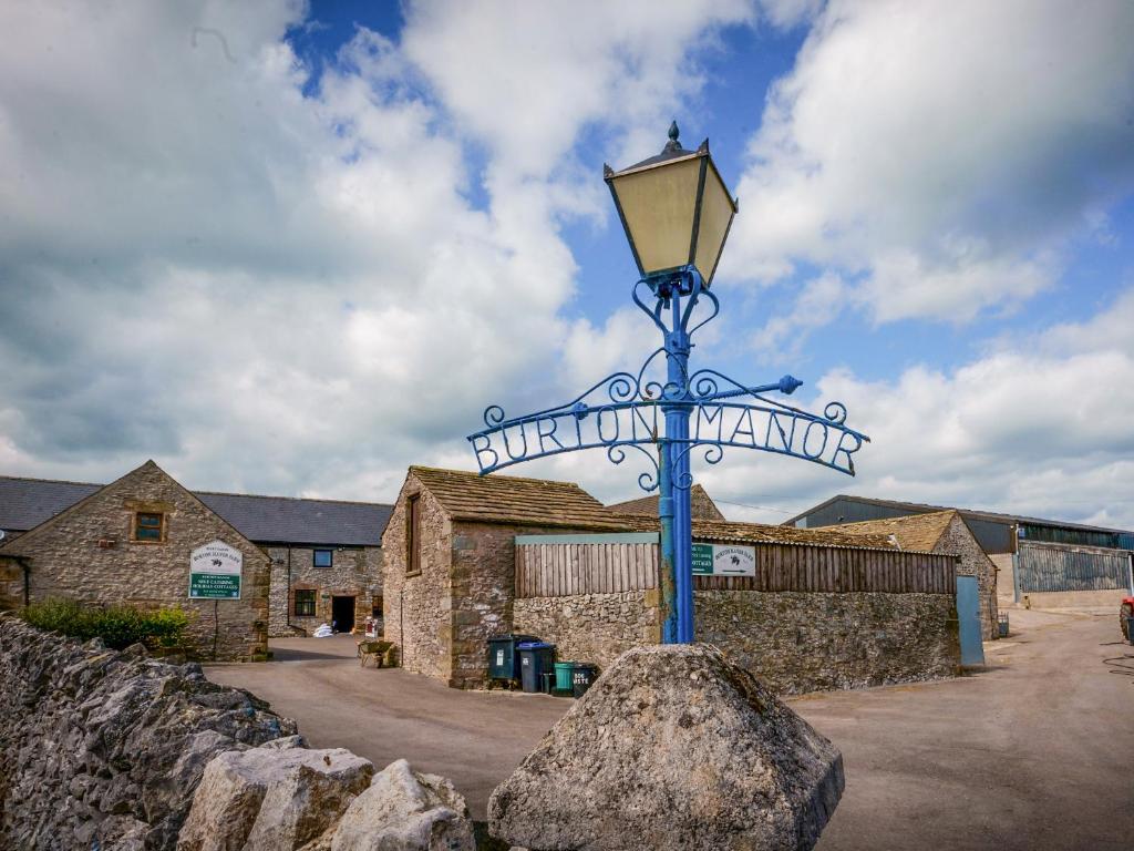 a street sign on a pole in front of a building at Lathkill Cottage in Bakewell