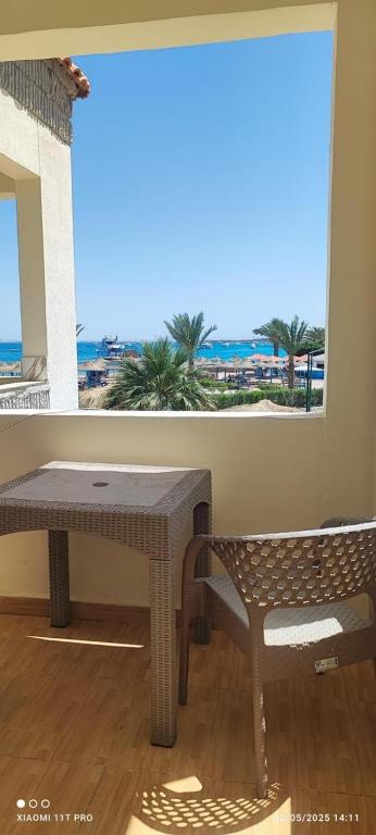 a table and a bench in a room with a window at porto view red sea in Hurghada