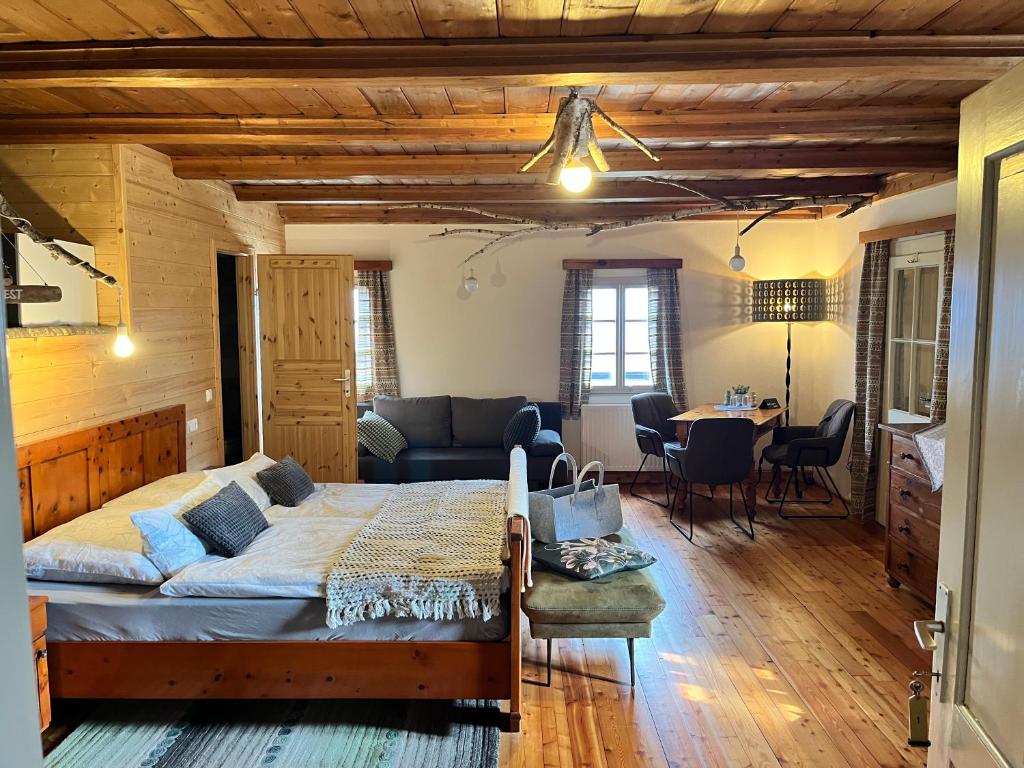 a bedroom with a bed and a living room at Landgasthof Marhube in Baldramsdorf