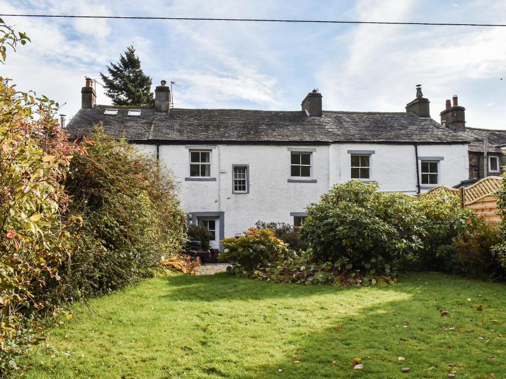 a white house with a yard in front of it at Dunmallet in Pooley Bridge