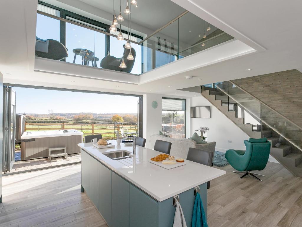 an open kitchen and living room with a large window at The Retreat - Ukc3845 in Ticknall