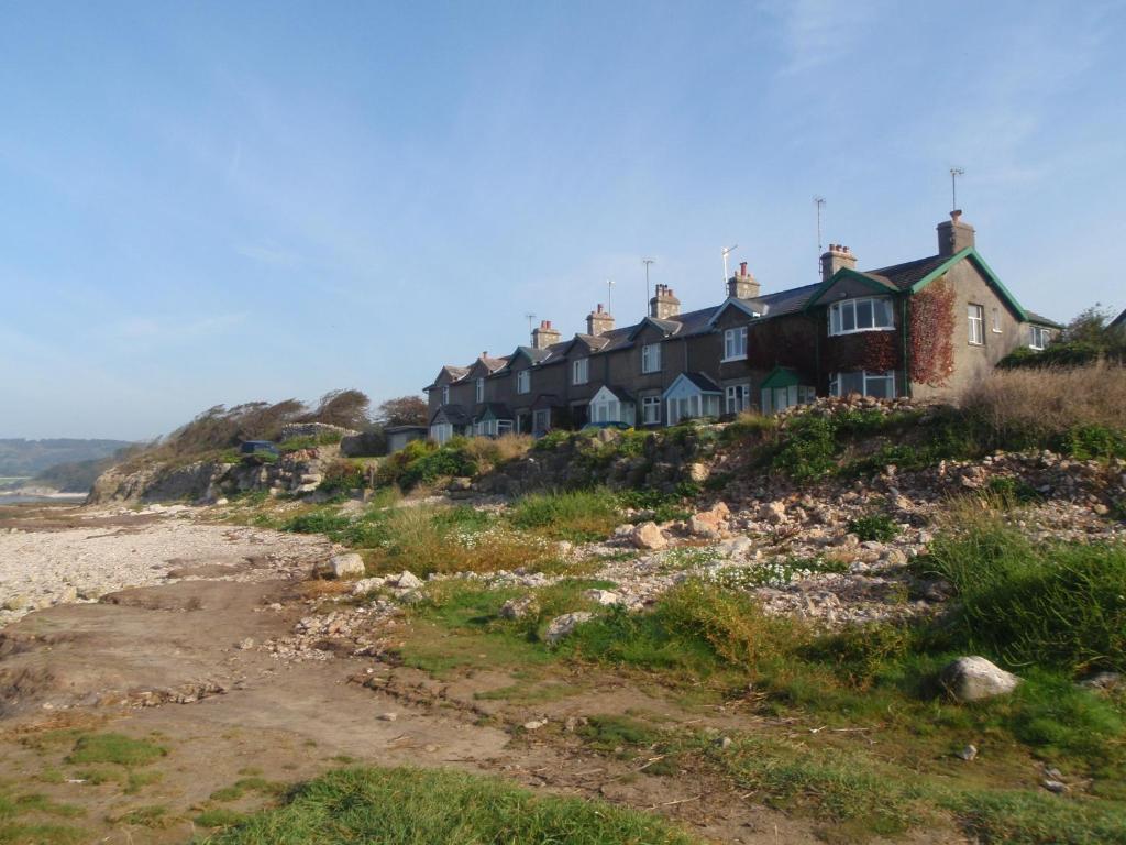 a row of houses on a hill next to the beach at Shore Cottage in Silverdale