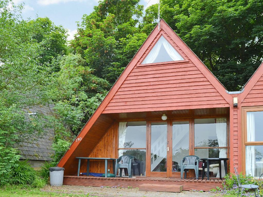 a house with a pitched roof with a table and chairs at Bay View in Kingsdown