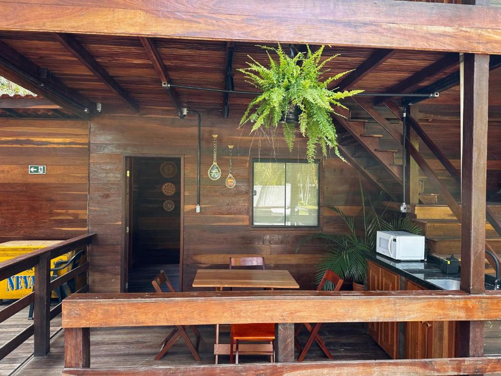 a dining room with a bench and a table at Hotel e Restaurante Tribo Combú in Belém
