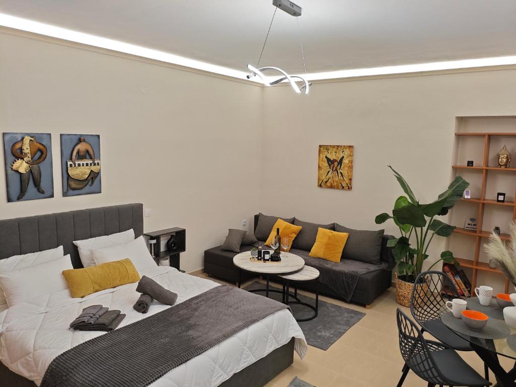 a living room with a bed and a couch at Kerkétio guesthouse in Tríkala