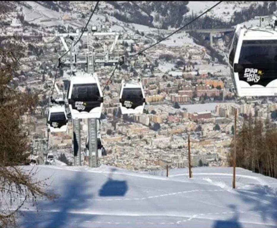 three gondolas on a ski lift in the snow at casa rita in Gressan