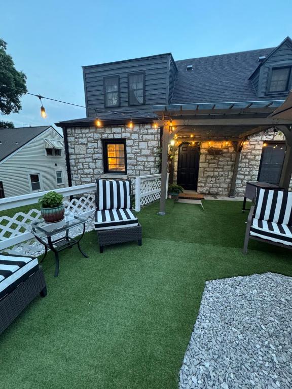 a patio with two chairs and a table and a house at 5 BR 4 Bath Dutch Cottage 3 ml from Buffalo Trace in Frankfort