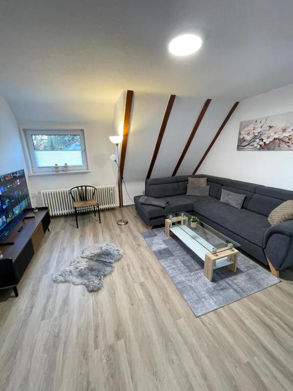 a living room with a couch and a table at HarzRoots A mit Garage in Bad Harzburg