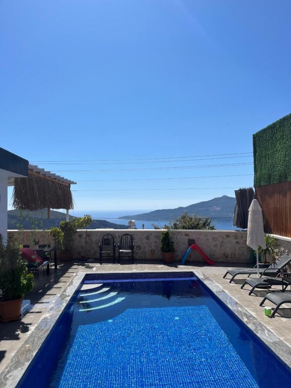 a swimming pool with a view of the ocean at Villa karya in Kas