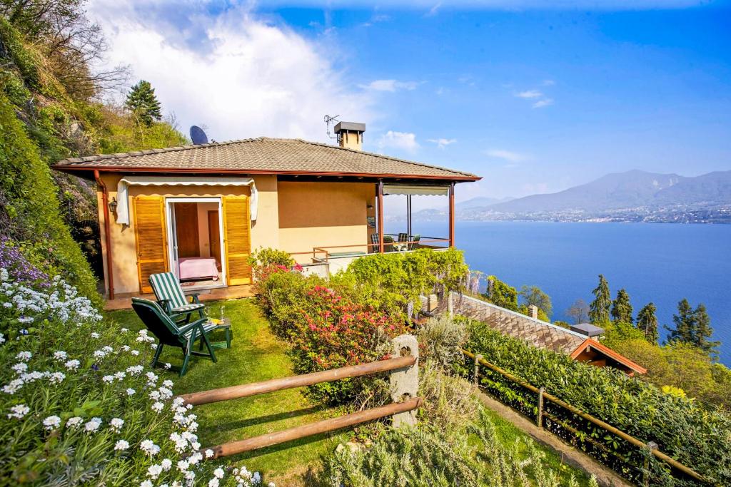 a house on a hill with a view of the water at Residenz Roccolo in Ghiffa