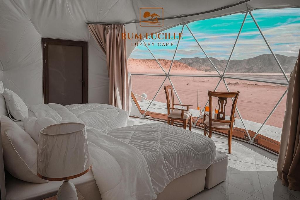 a bedroom with a bed and a view of a beach at RUM LUCILLE lUXURY CAMP in Wadi Rum