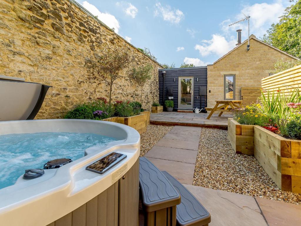 a hot tub in the backyard of a house at Rinstone Lodge in Thornton Dale