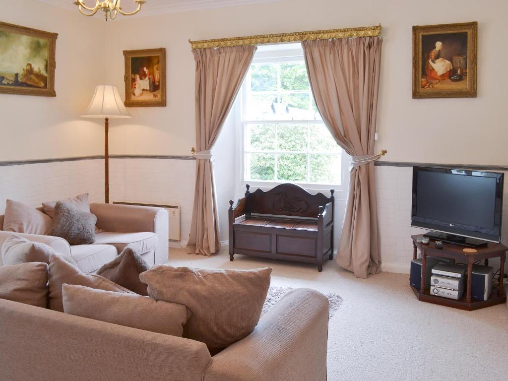 a living room with a couch and a tv at Caradon Apt - Cv14 in Saint Cleer