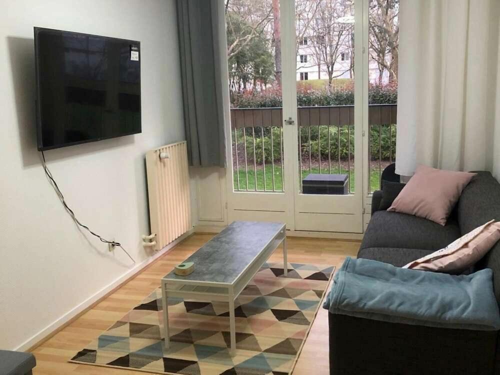 a living room with a couch and a coffee table at Chambre Privée Cosy- Dans Appartement Moderne en Colocation- Tram A -P2-4 in Lormont