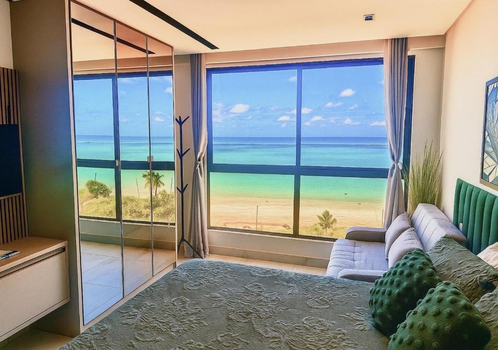 a living room with a view of the ocean at Flat Vista-Mar in Cabedelo