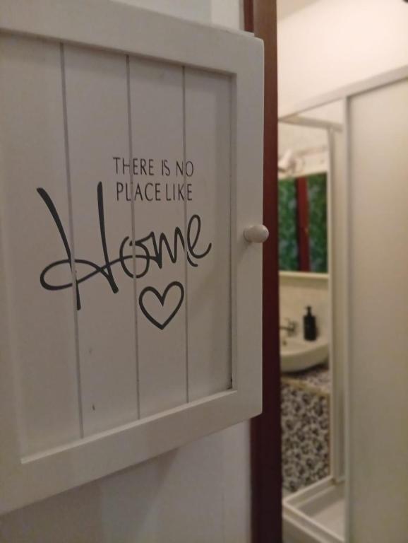 a door with a sign that says there is no place like home at B&B Rivoli in Rivoli