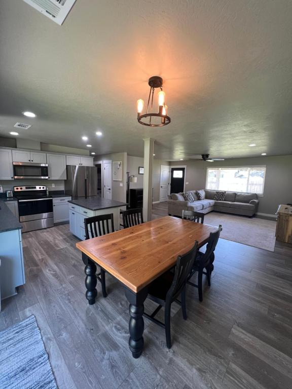 a kitchen and living room with a wooden table and chairs at Rest and Retreat River House in Grants Pass