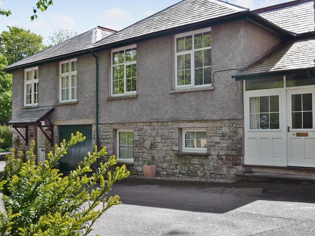 a brick house with a white garage door at Hope Cottage in Lindale