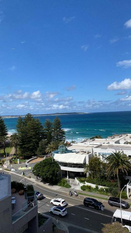a view of a street with a building and the ocean at The Oceanfront Sanctuary Spa & Parking in Cronulla