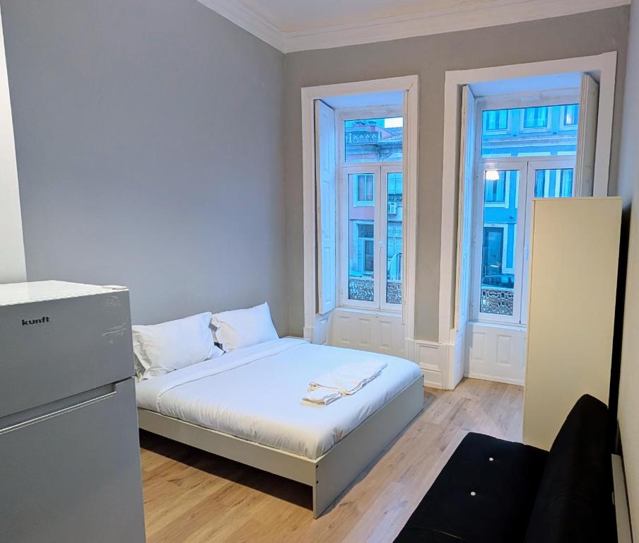 En eller flere senge i et værelse på Riko Guest House 2