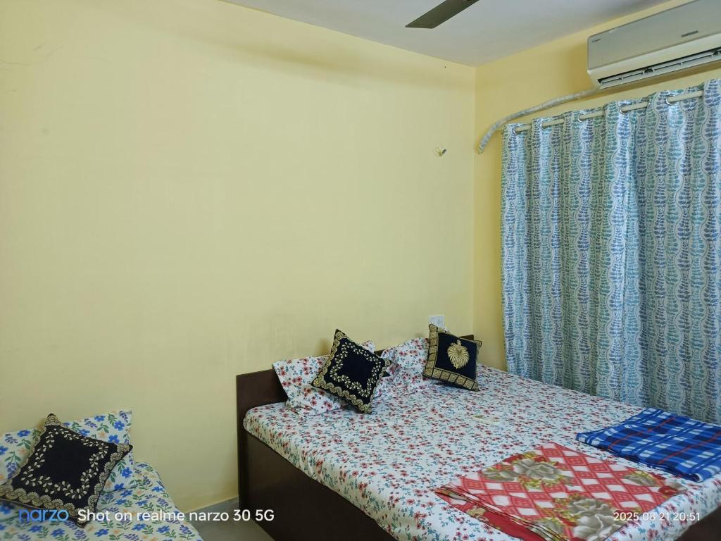 um quarto com uma cama com travesseiros em Private Room At Pushpanjali Residency Phase 2 Ghodbunder Road Ovale Thane West em Kolshet
