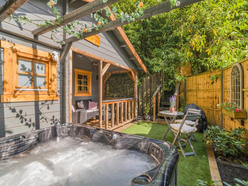 a hot tub in the backyard of a house at The Lodge - Uk50409 in Bisterne