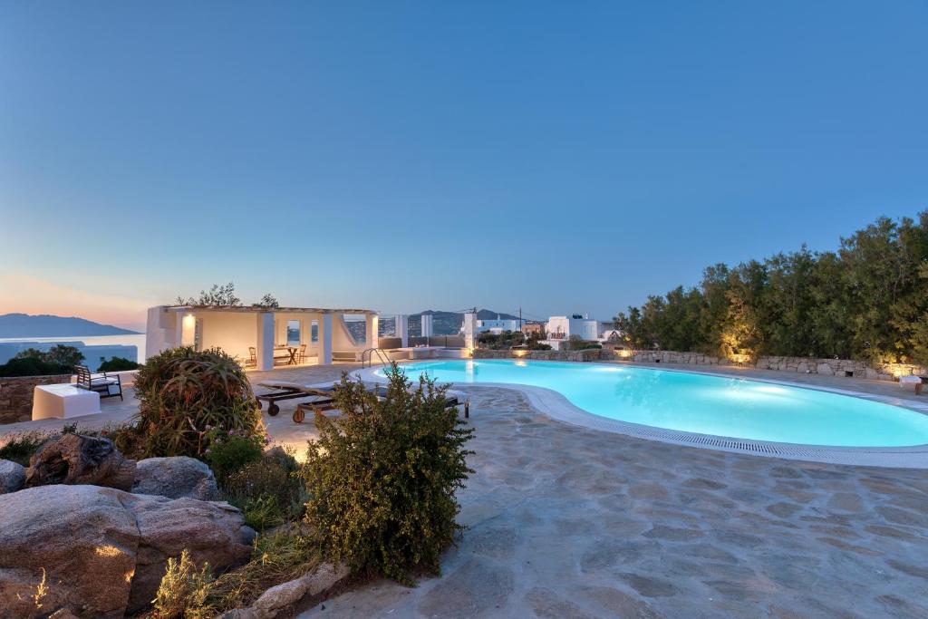 a swimming pool in the middle of a resort at Villa Zanetti Mykonos in Agios Ioannis Mykonos