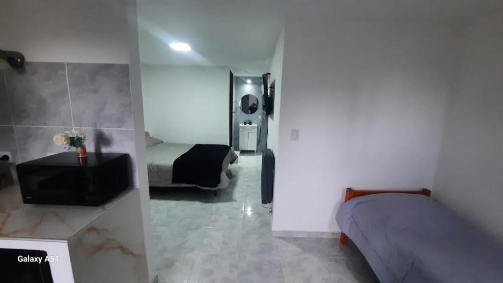 a room with two beds and a table in it at Rada Tilly Apart 2 Unidad 6 in Rada Tilly