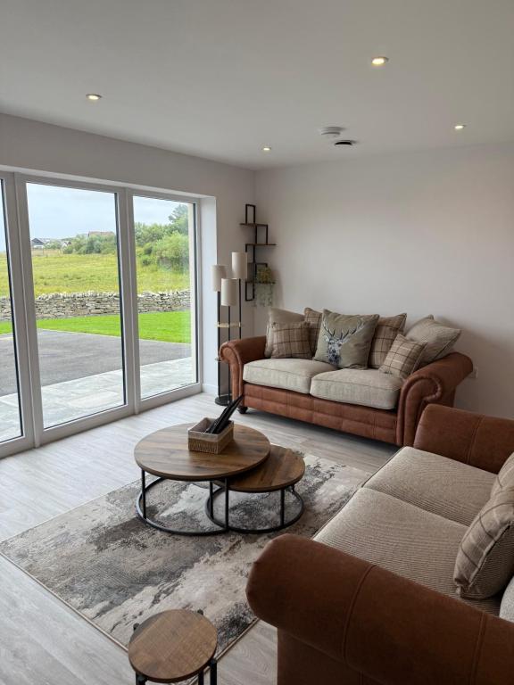 a living room with two couches and a table at Stylish Cosy Stunning View Villa in Kirkwall, Free Parking and WiFi in Orkney