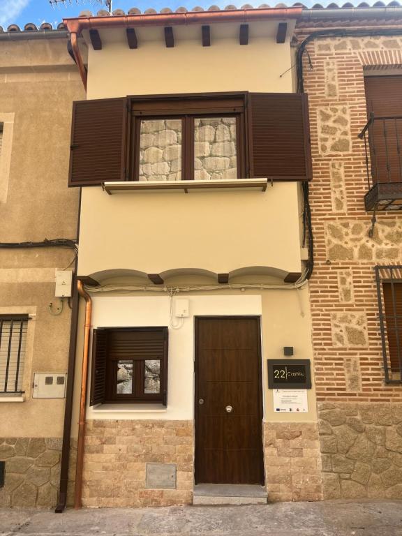 a building with a door and two windows at Castillo 22 in Oropesa