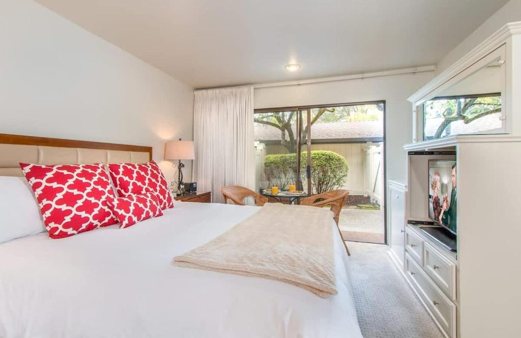 a bedroom with a white bed with a red pillow at Romantic Napa Escape Prime Location in Vichy Springs