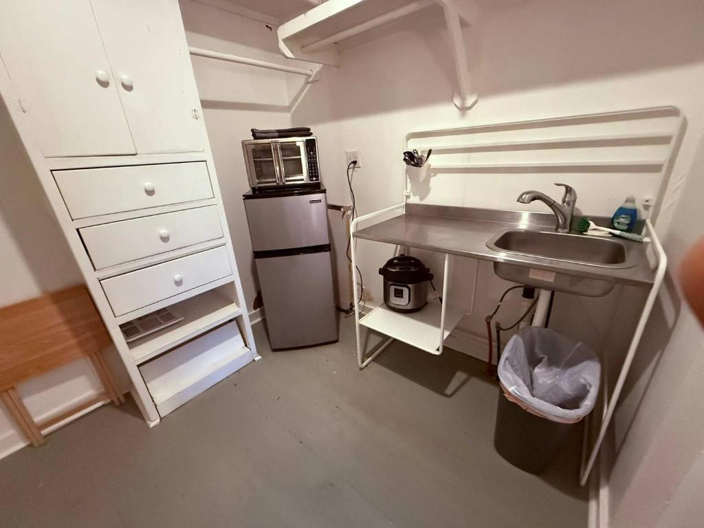 a small kitchen with a sink and a microwave at Peaceful Guest Suite with Microwave & Fridge in Lafayette