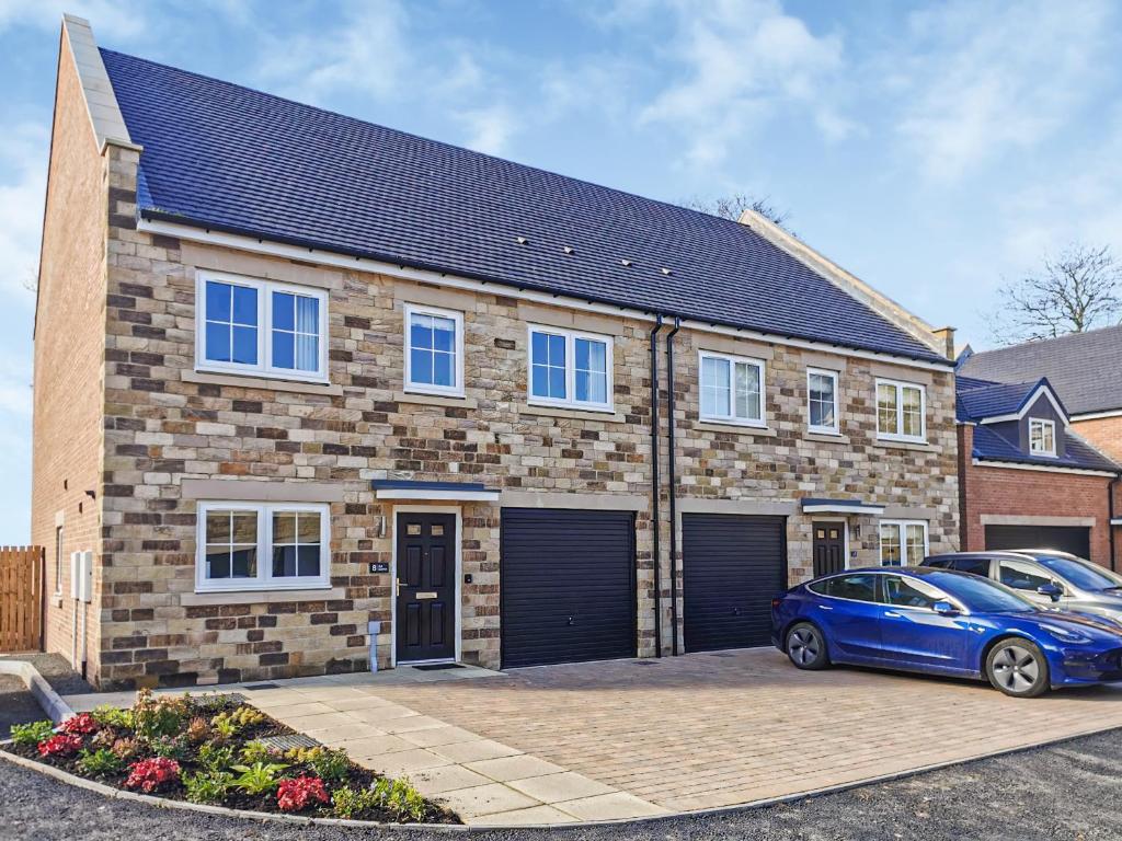 a brick house with a car parked in front of it at Ad Gefrin in Acklington