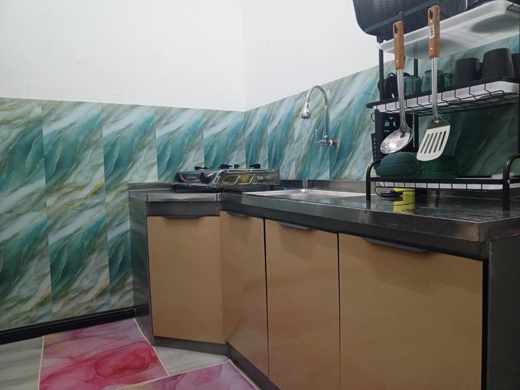 a kitchen with a fish mural on the wall at Bae Homestay Taman Mega Alor Setar Wi-Fi Netflix 