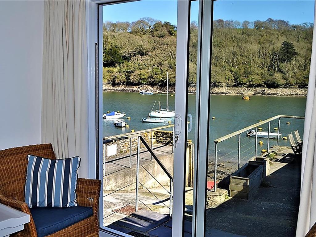 a balcony with a view of a body of water at Tarquins in Fowey
