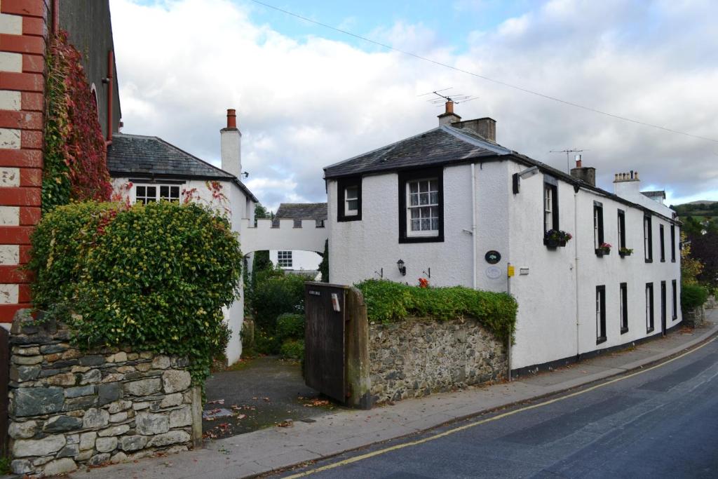 a white house on the side of a street at Acorn Lodge Cottage in Keswick