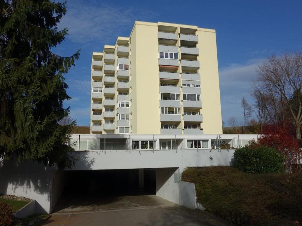 a large yellow building with a bridge in front of it at Holiday apartment with 1 bedroom in Meersburg